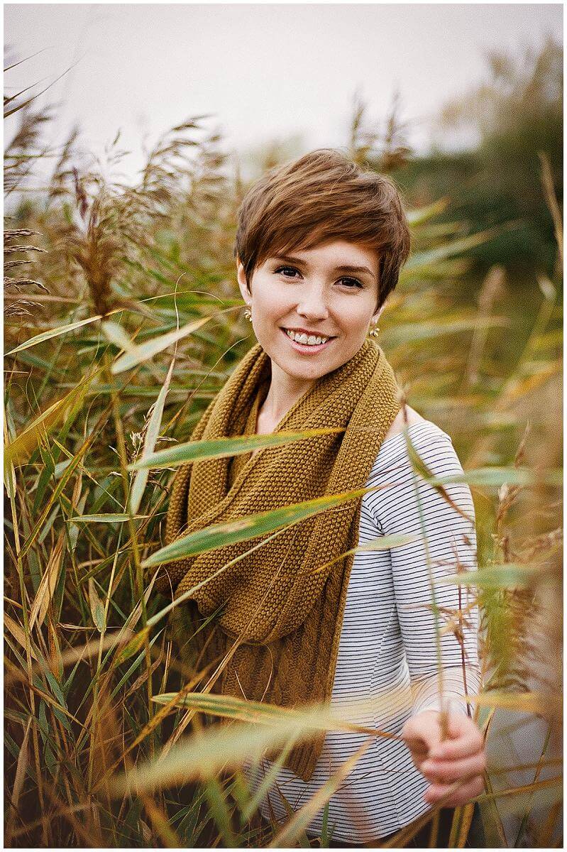 happy girl standing in reeds