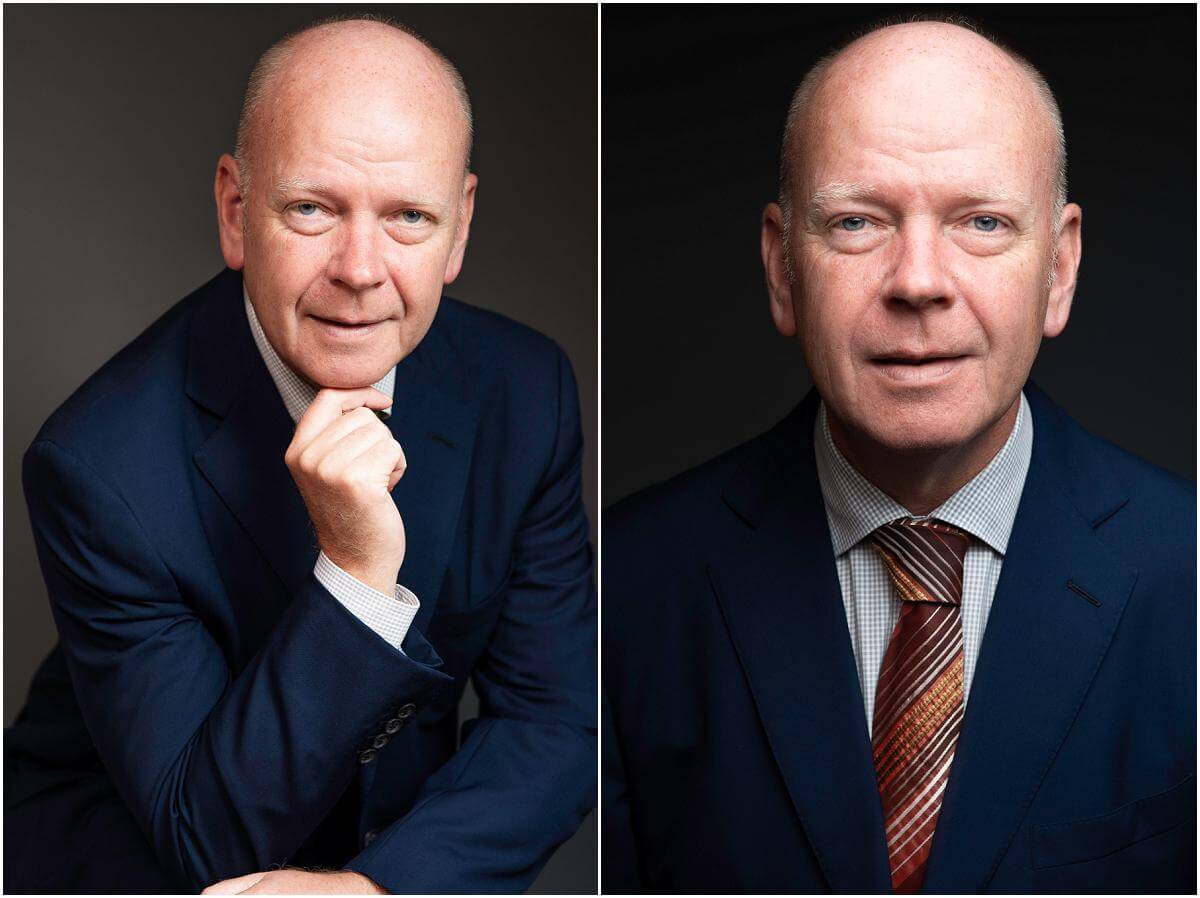 man smiles wearing suit